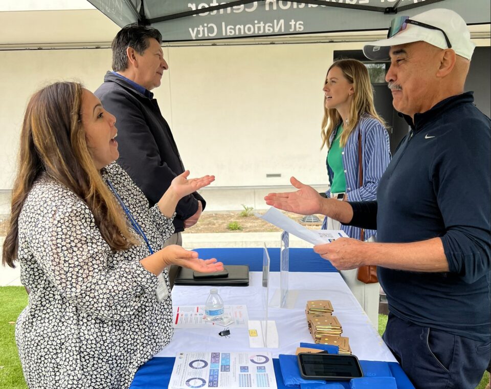 people talk over an information table