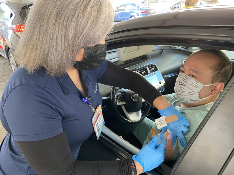 man inside car gets vaccination