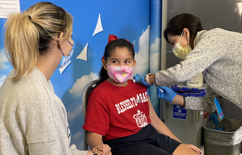 A child gets vaccinated against COVID-19.