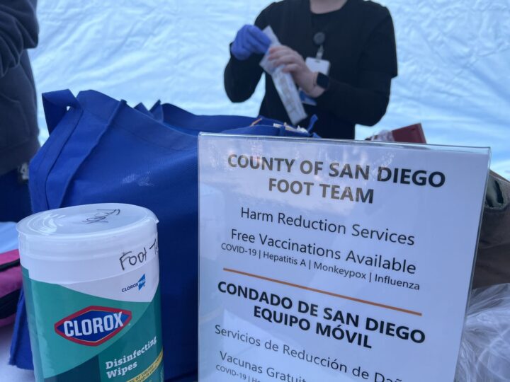Sign of San Diego County Foot Team Vaccinations. Nurse in background