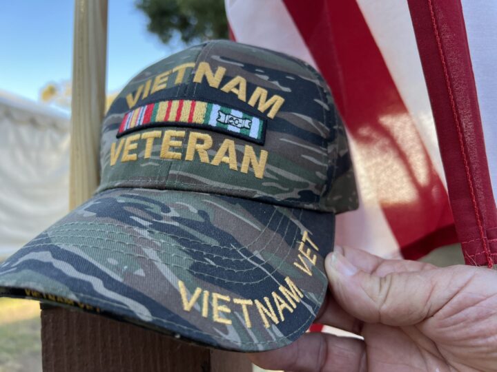 Vietnam veteran hat in front of American flag
