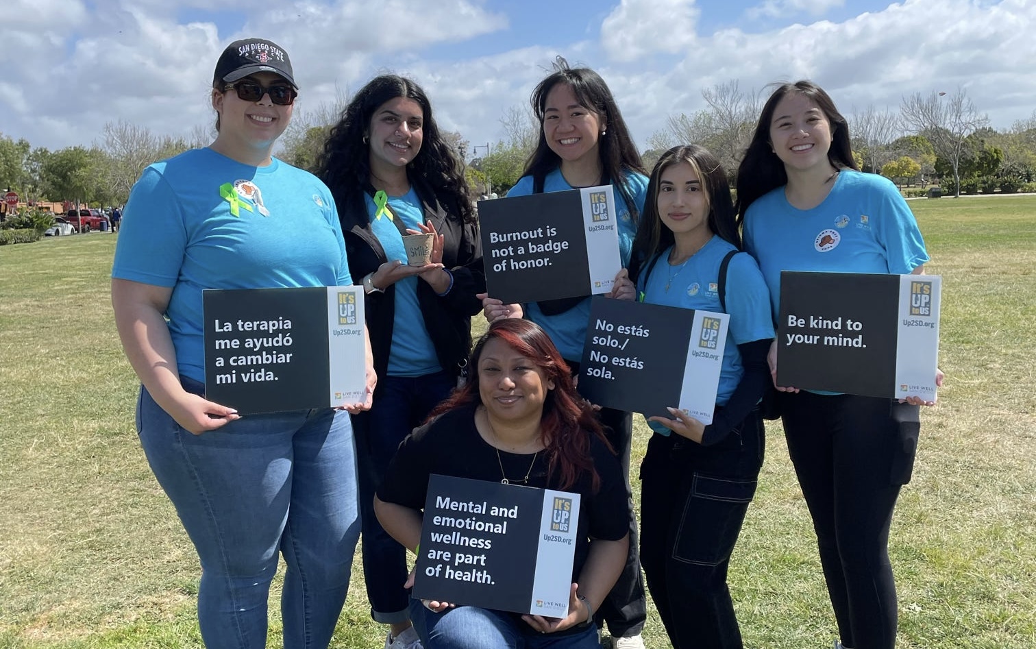 Behavioral Health Staff at NAMIWalk San Diego holding mental health awareness signs