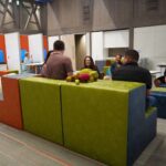 a group of people sit in an open seating area