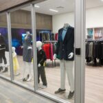 a storefront with mannequins in the window