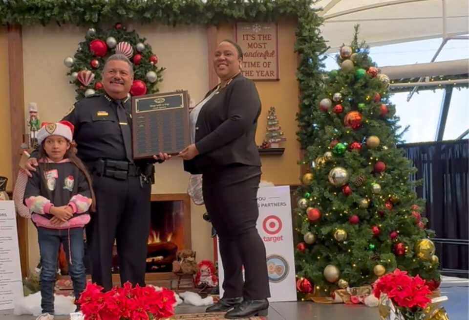 Child with National City Police Chief Passing Plaque to Probation Chief