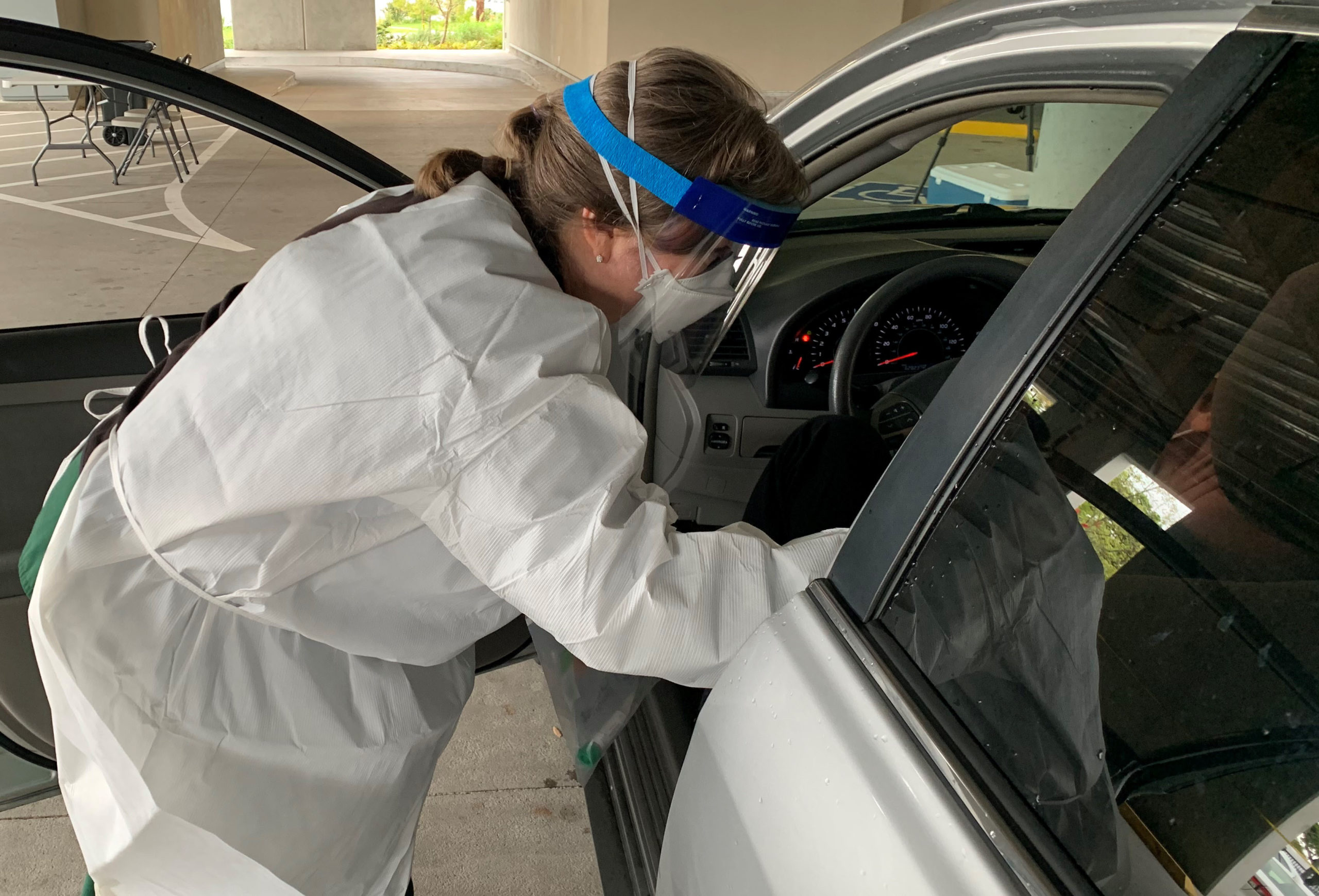 nurse testing a patient in a car