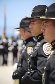 the side profile of several uniformed law enforcement standing in line