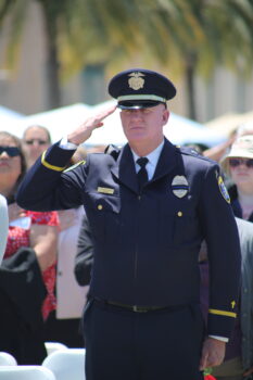 a uniformed officer standing at salute