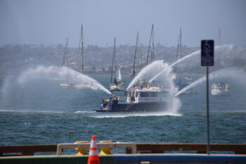 a boat sprays four streams of water into the sky