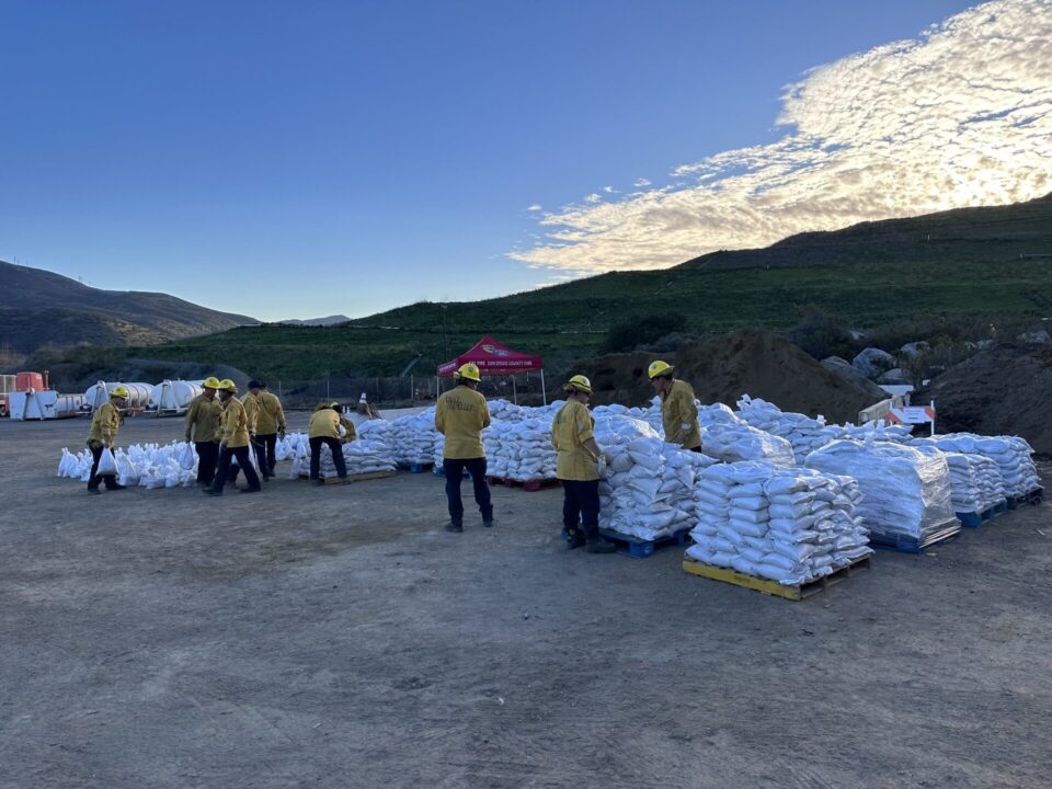 County Fire/CAL FIRE firefighters filling and stacking sandbags
