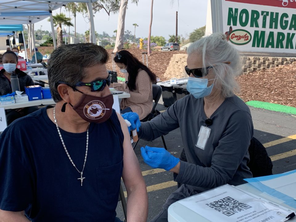 A man gets vaccinated at a mobile clinic
