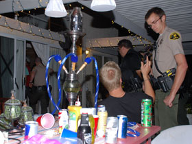 Sheriff talking to a teen at a house party