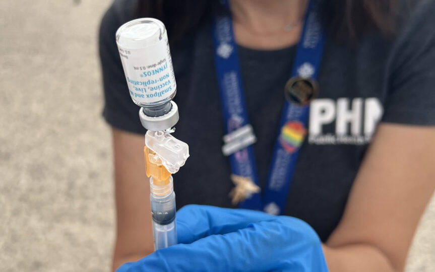 Close up of Public Health nurse holding JYNNEOS vaccine and injection