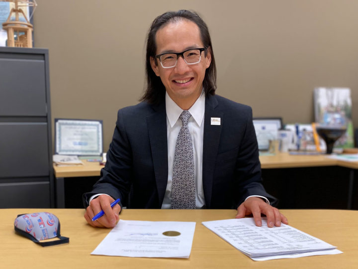 Michael Vu sitting at desk