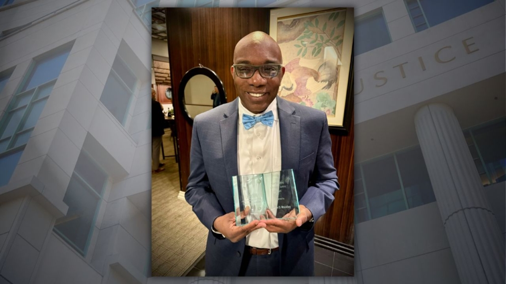 Assistant District Attorney Dwain Woodley with award