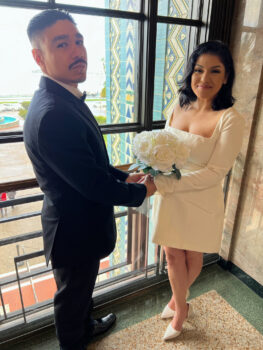 Couple faces each other holding hands and smiling