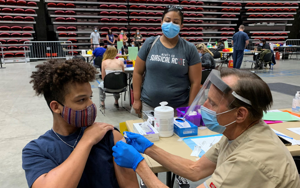 Teenage boy gets his COVID-19 vaccination.