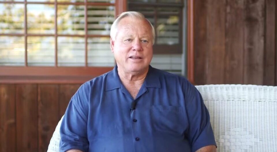 Bill Horn sitting on sofa talking about his military service