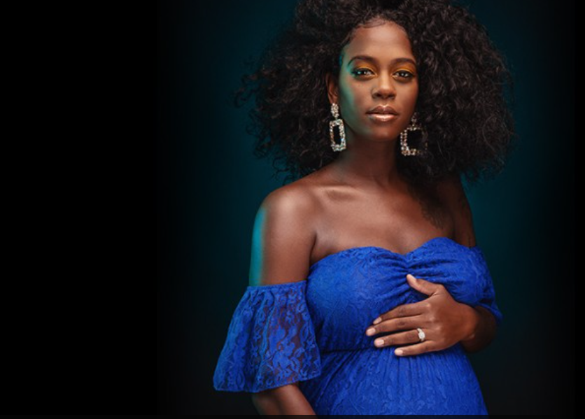 African American pregnant woman in blue dress