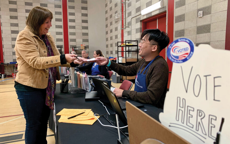 someone handing in a ballot