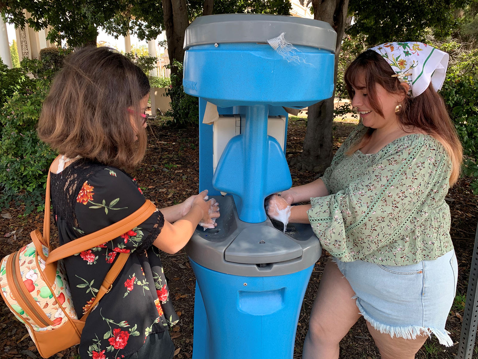 two people using a handwashing station