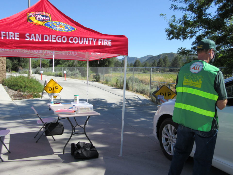 Photo showing a CERT volunteer helping county residents during COVID testing in Pine Valley.