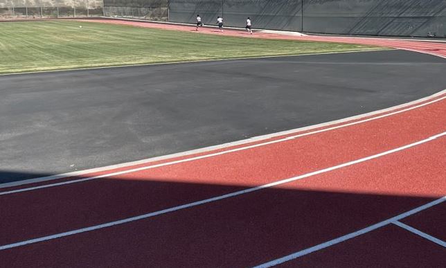Justice-involved youth running on a new running track