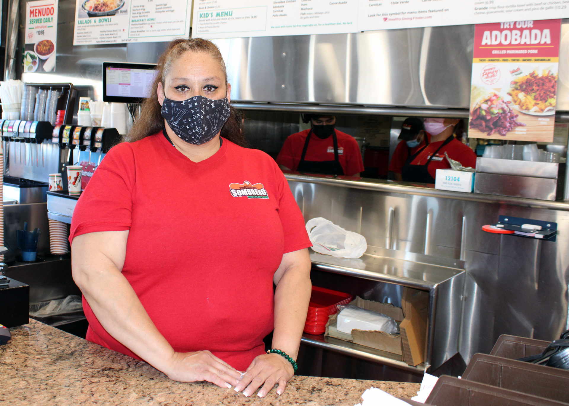 Angela Carapia stands at restaurant counter