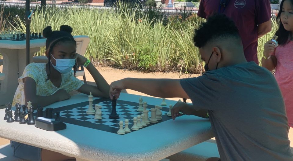 children playing chess outside