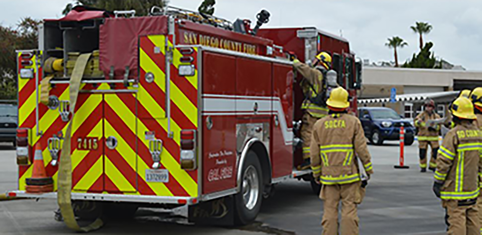 Picture of several County fire trucks and firefighters,