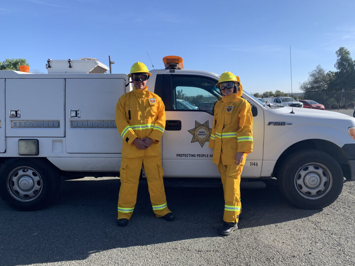 Two County Animal Control officers in fire protective gear for responses.