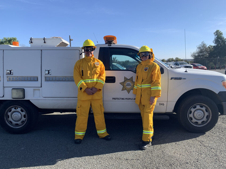 Two County Animal Control officers in fire protective gear for responses.