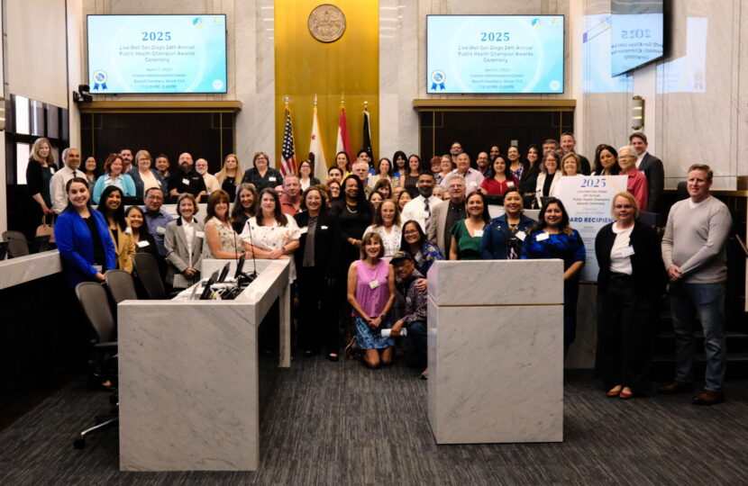 big group gathers and smiles in the chambers