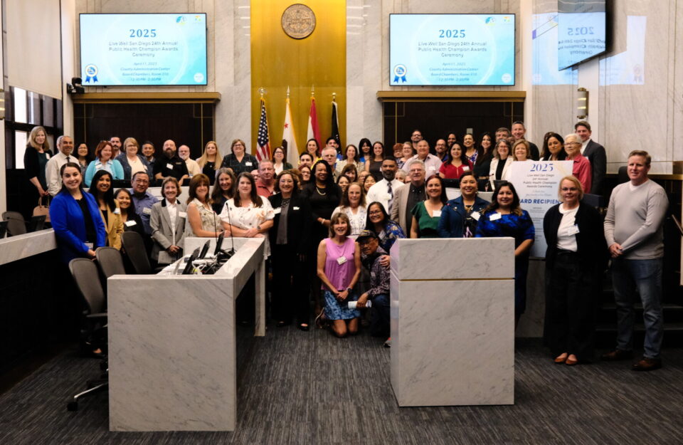 big group gathers and smiles in the chambers