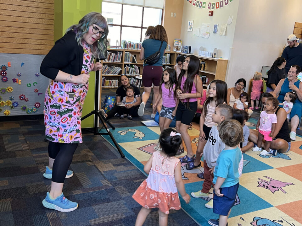 librarian interacts with children in library