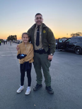 Sheriff's deputy with his child partner get ready to start their fun day.
