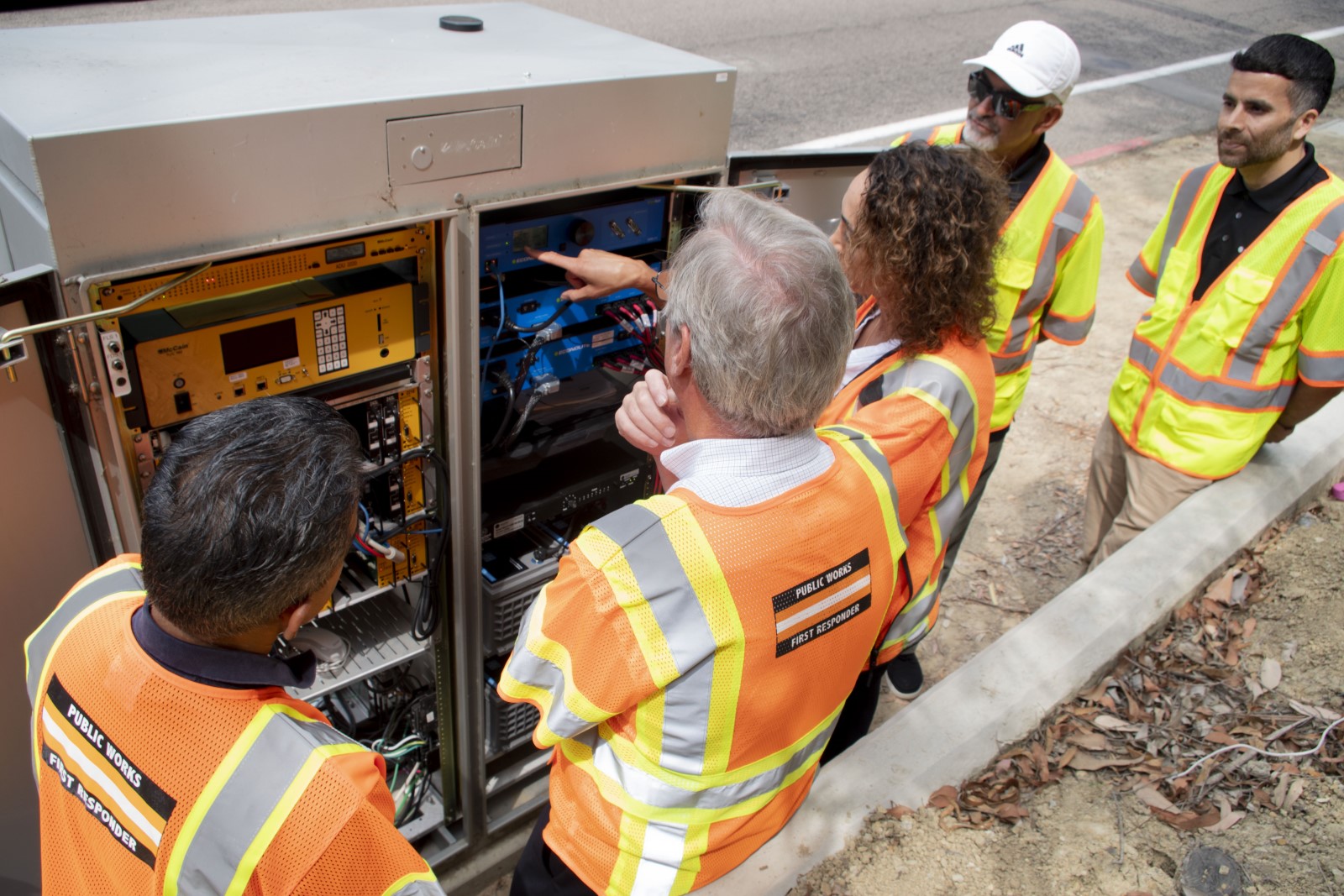 public work employees look at a new backup battery system