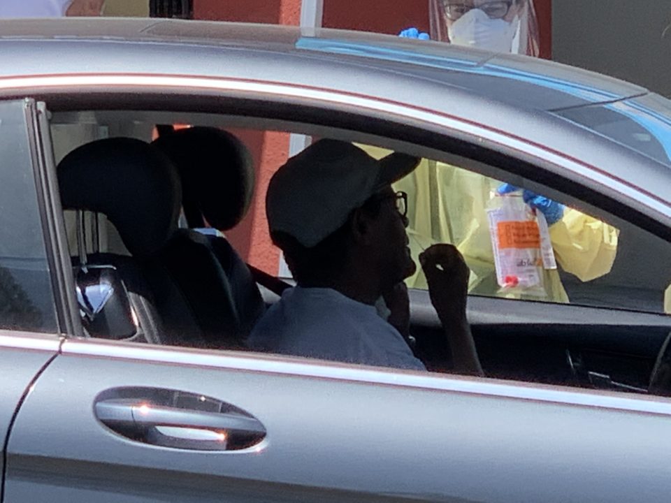 Man in car at COVID-19 test site