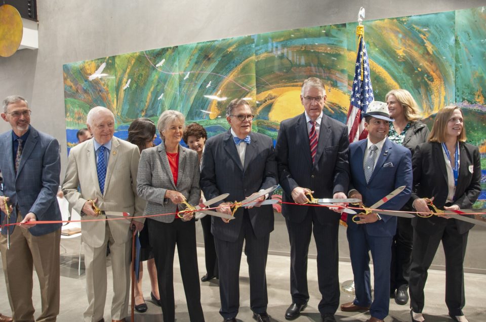 officials cutting a large ribbon