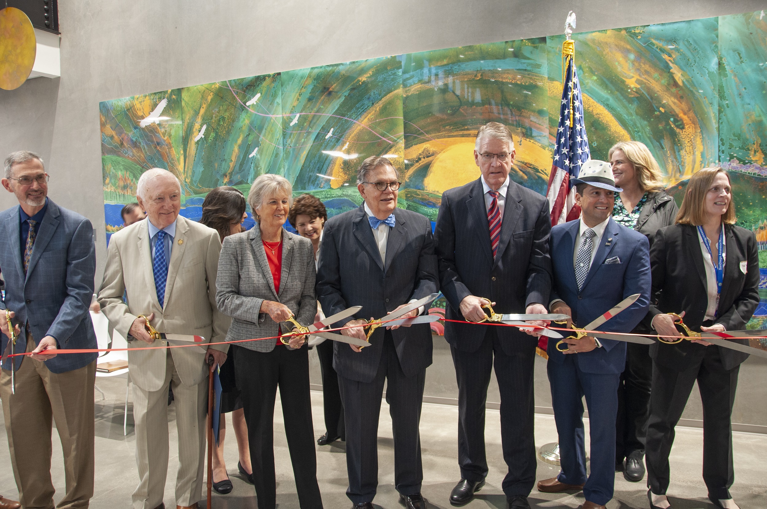 officials cutting a large ribbon