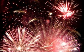 Fireworks exploding in the night sky.