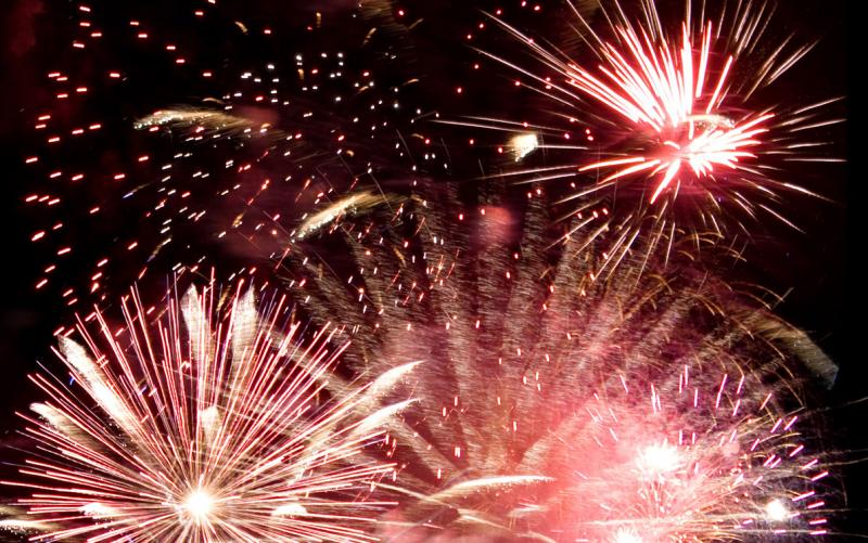 Fireworks exploding in the night sky.