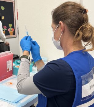Nurse preparing needle for flu shot