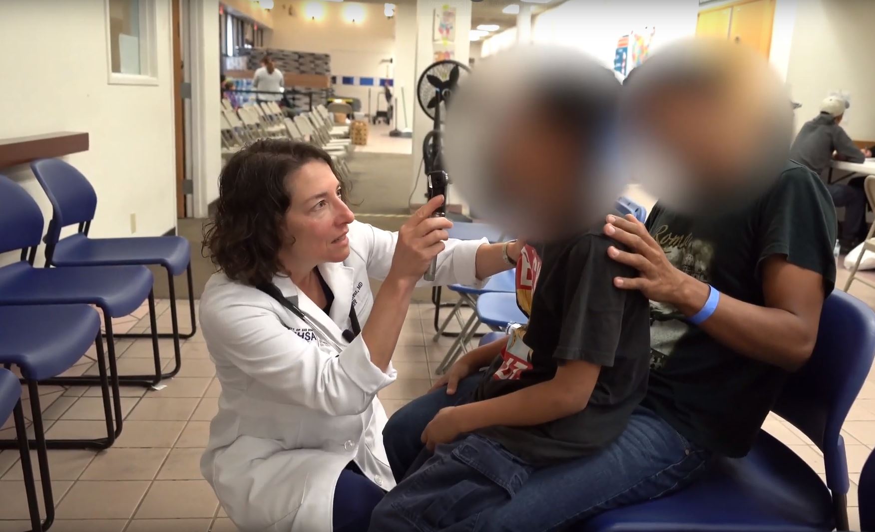 Medical professional examines a patient.