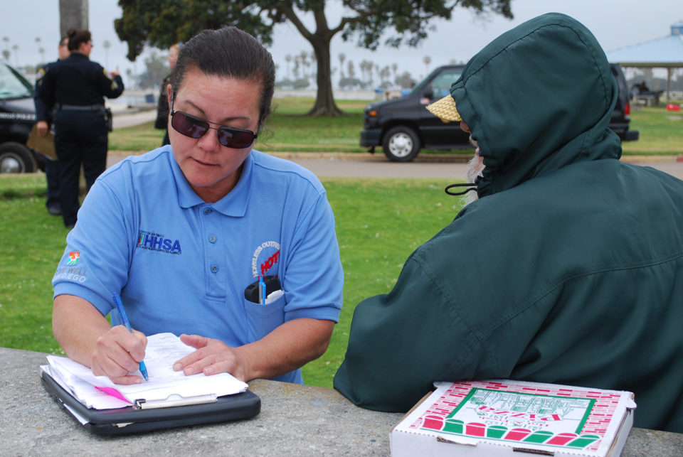 a homeless outreach team member talks to a homeless person