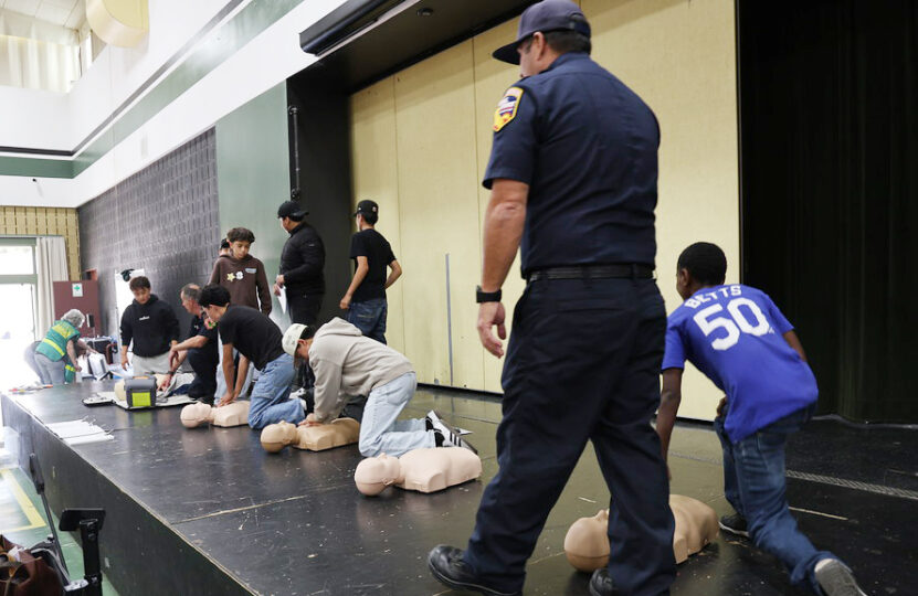 Students learning CPR with mannequins
