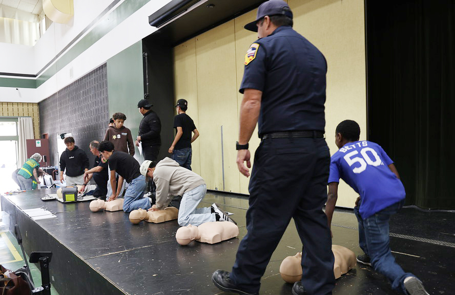 Students learning CPR with mannequins