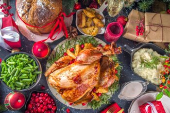 turkey and all the fixings on a table with holiday decorations