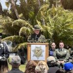 Officer speaking at podium in front of County Administration Center