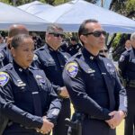 Officers watch memorial ceremony in front of County Administration Center
